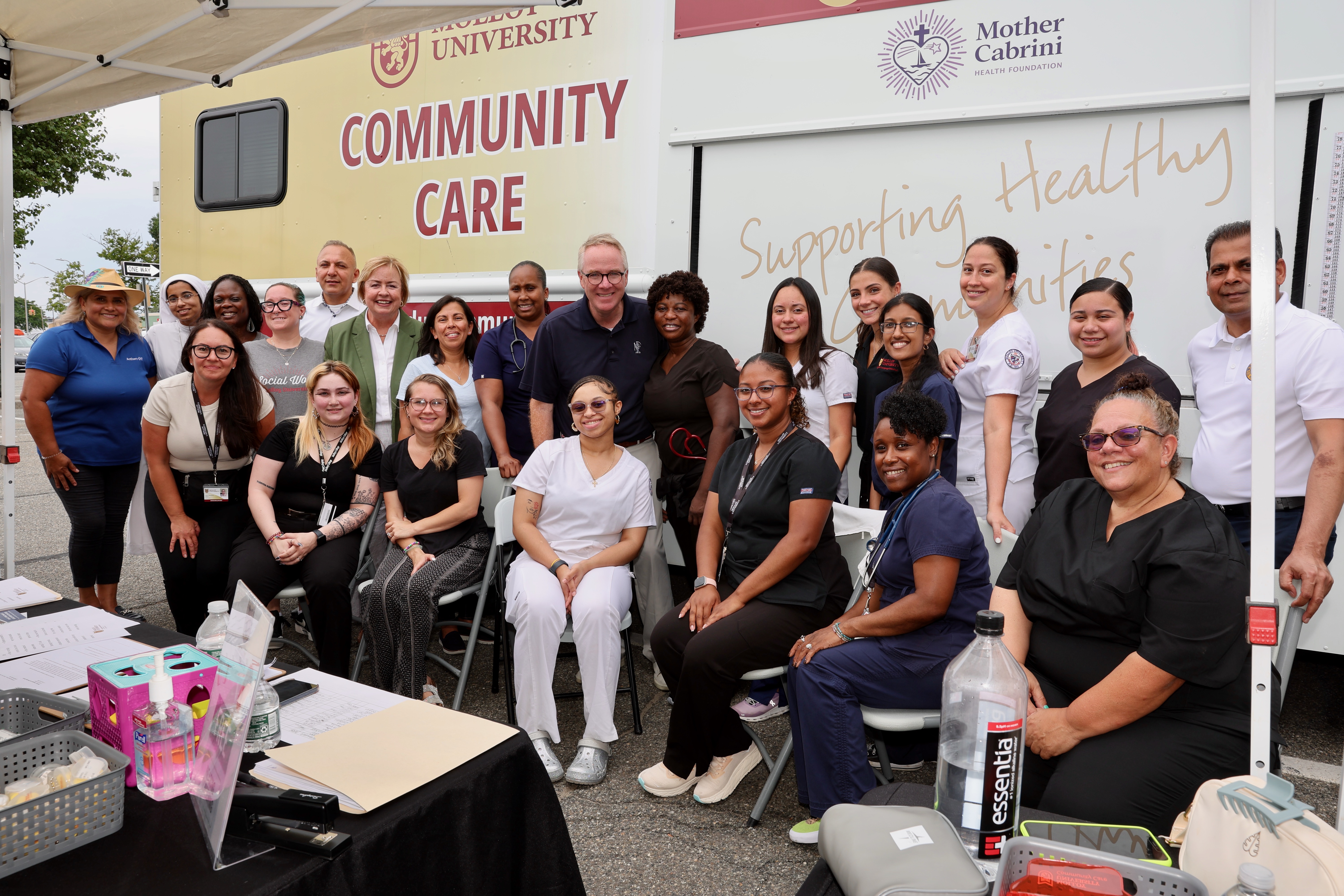 mobile clinic with sign that says free health screenings