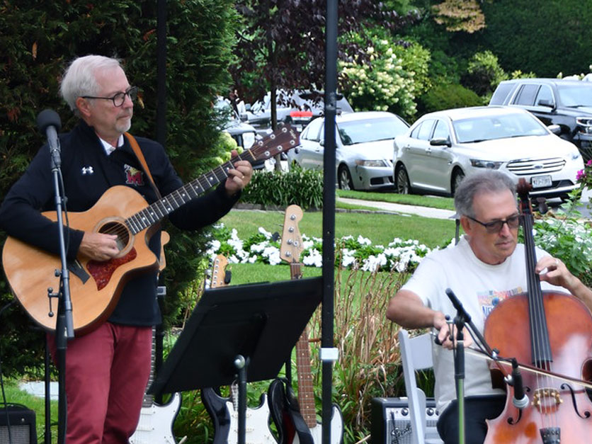 President Lentini plays guitar at Molloy University Community Day