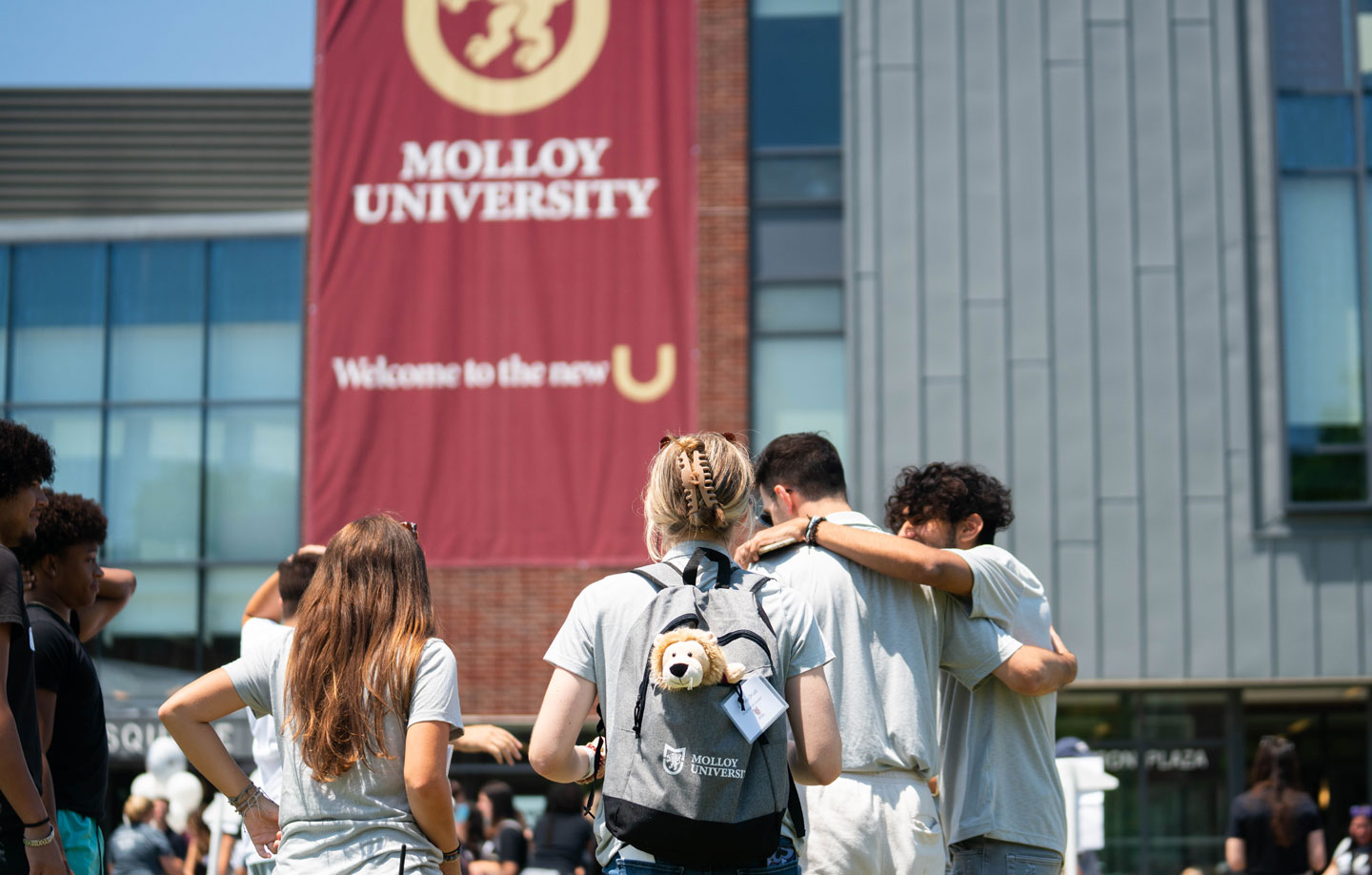 Molloy University students huddled in front of Public Square