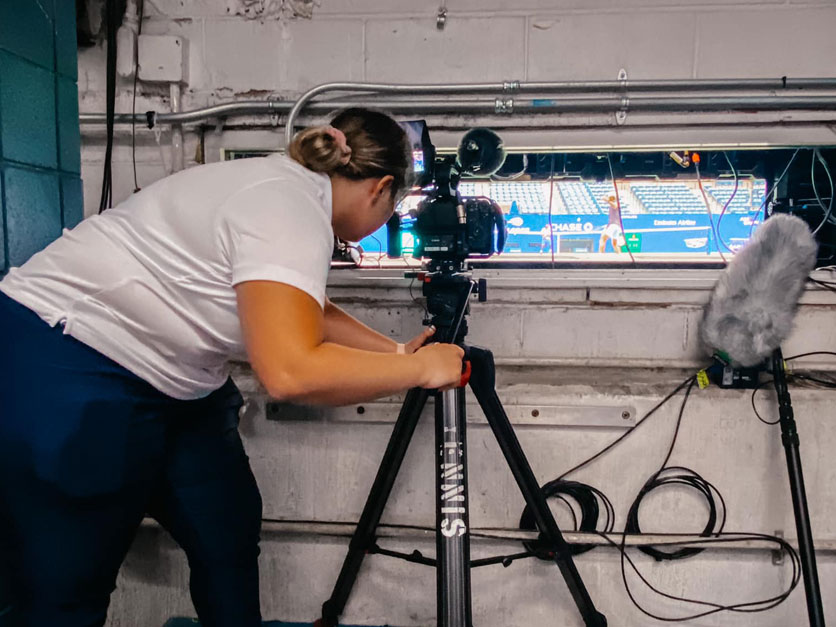 Bernadette Conway in the Photographers pit filming the U.S. Open