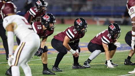 Group of Molloy Lions sprint football player on the field